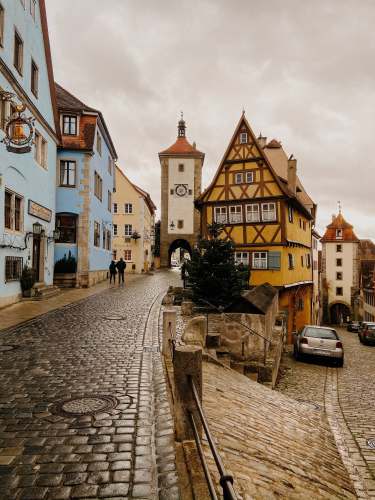 rothenburg ob der tauber cars parked beside concrete building during daytime walkway